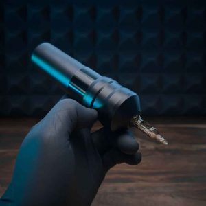 hand holding a ACUS M1 PLUS Pen tattoo Machine