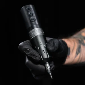 hand holding a PRIME x Critical Pen Wireless Tattoo Machine